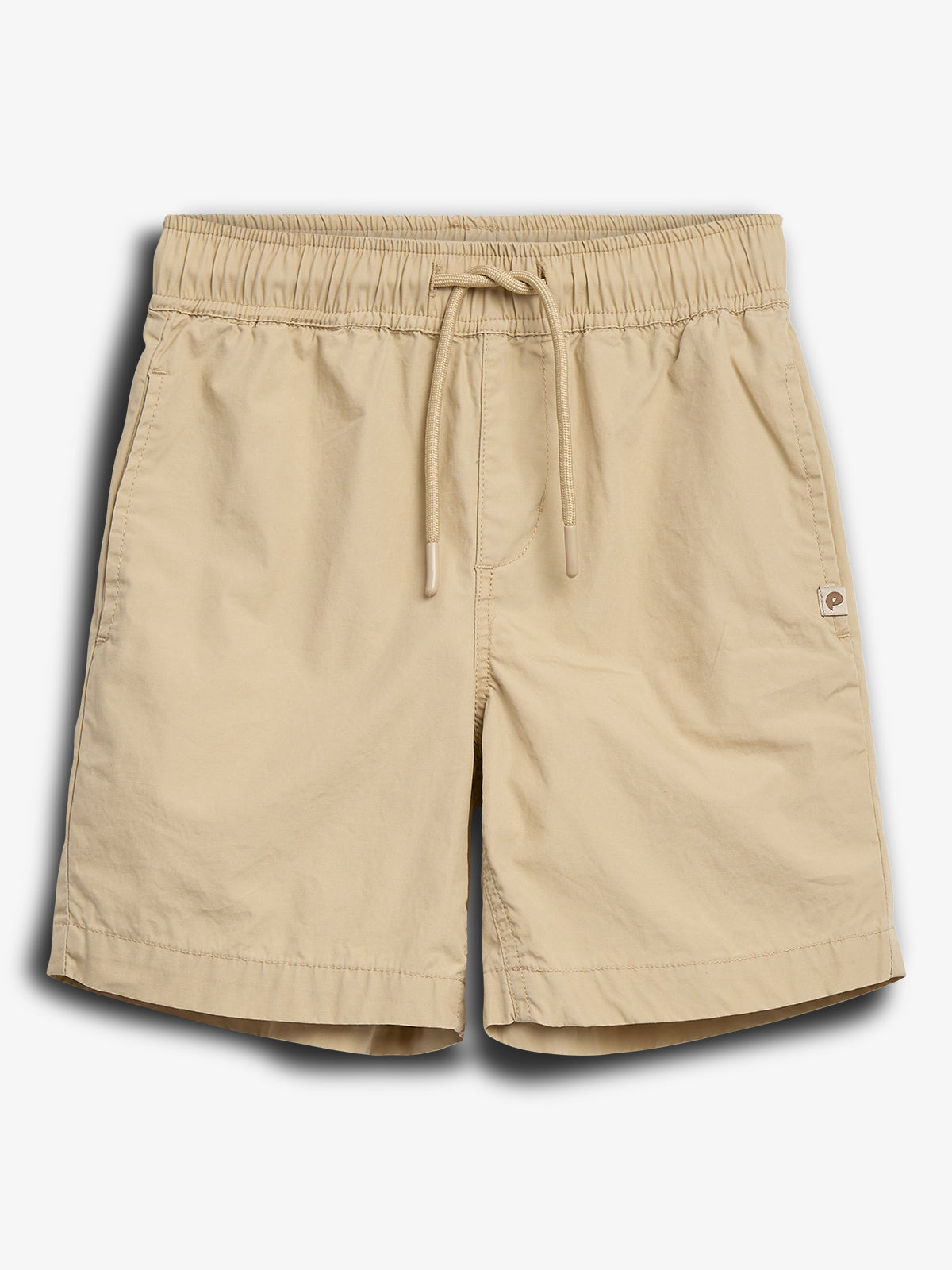 Beige shorts with an elastic waistband and drawstring, displayed on a plain white background. A small logo is visible near the right hem, adding a subtle design element.