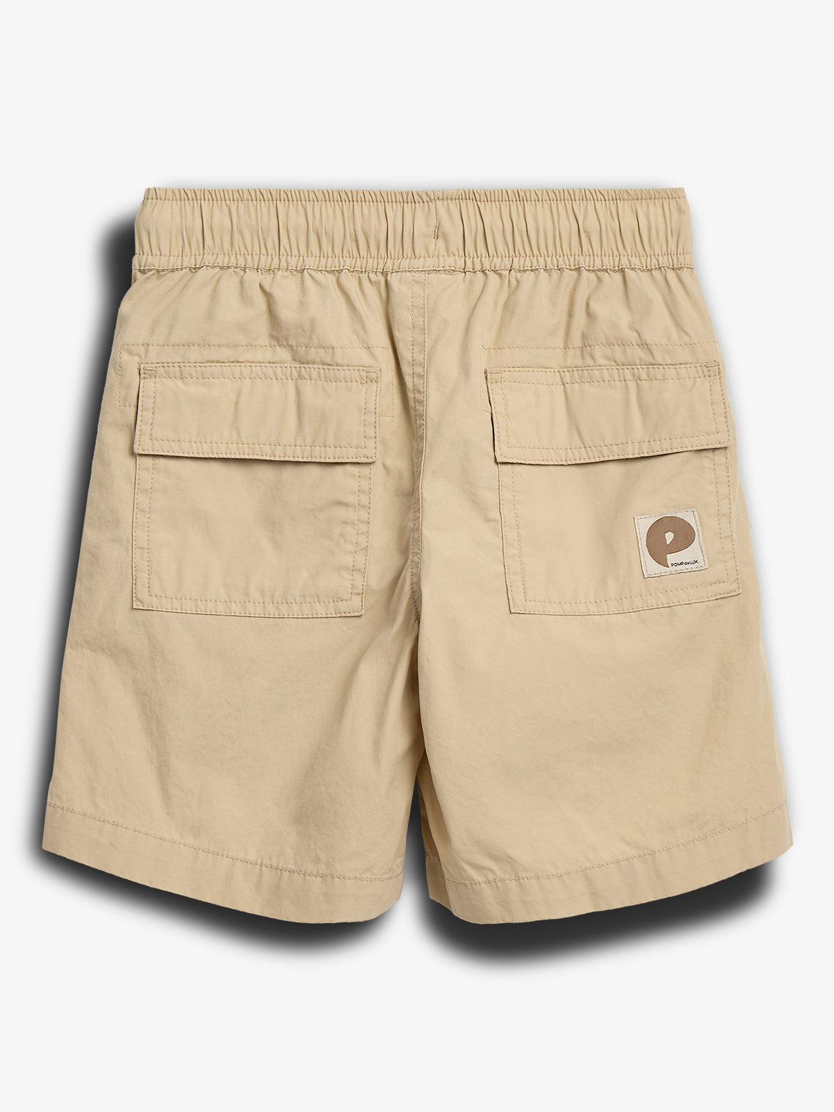 Beige shorts with an elastic waistband and two rear flap pockets. A small patch with a stylized "P" logo and "Polar Skate Co." text is on the right pocket.