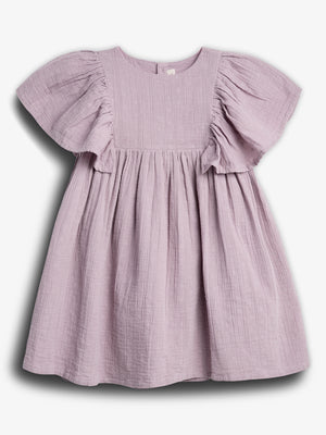 A lilac-colored, short-sleeved dress hangs against a plain white background, featuring a textured fabric with small embroidered patterns and a gathered, flowing skirt.