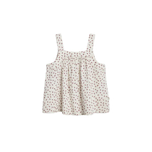 Sleeveless, floral-patterned dress with thick straps hangs against a plain backdrop. The fabric is light-colored with small, red floral designs scattered throughout.