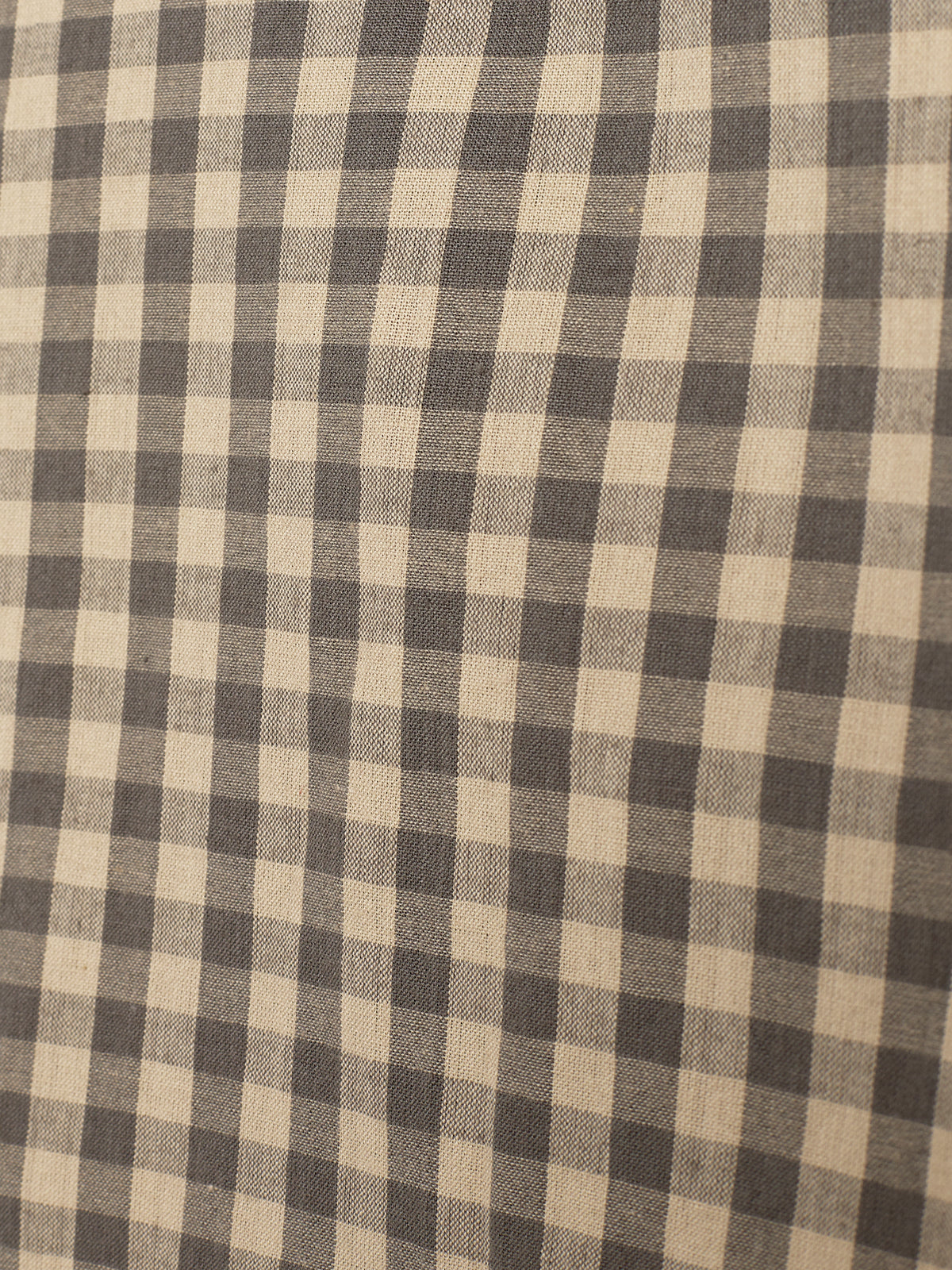 A fabric with a checkered pattern, featuring alternating dark and light squares, arranged in even rows and columns, creating a grid-like appearance across the entire surface.