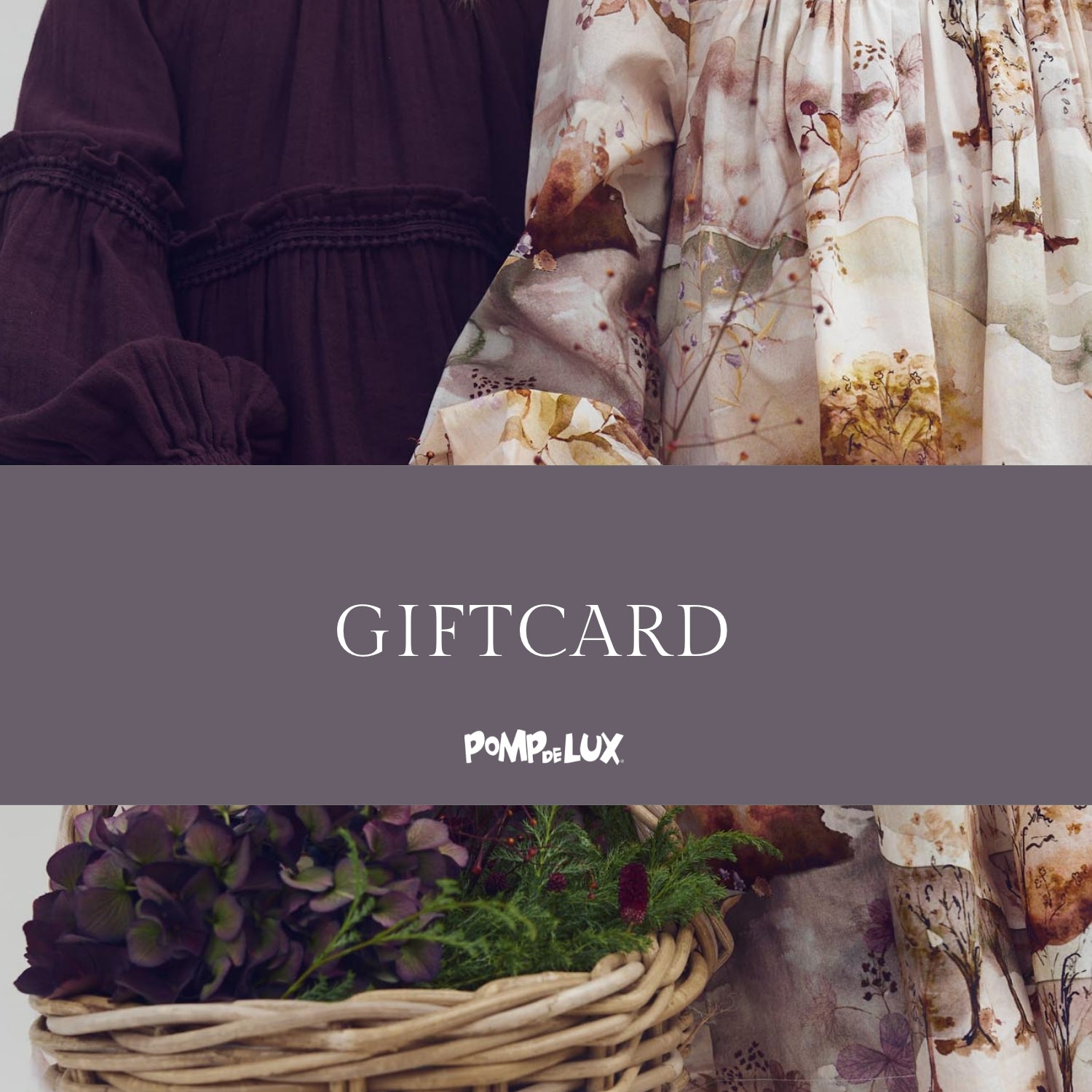 Two dresses, one dark and one floral, are displayed with gathered sleeves. Below, a woven basket holds dark purple and green foliage. Text reads "GIFTCARD POMPdeLUX" on a gray band.